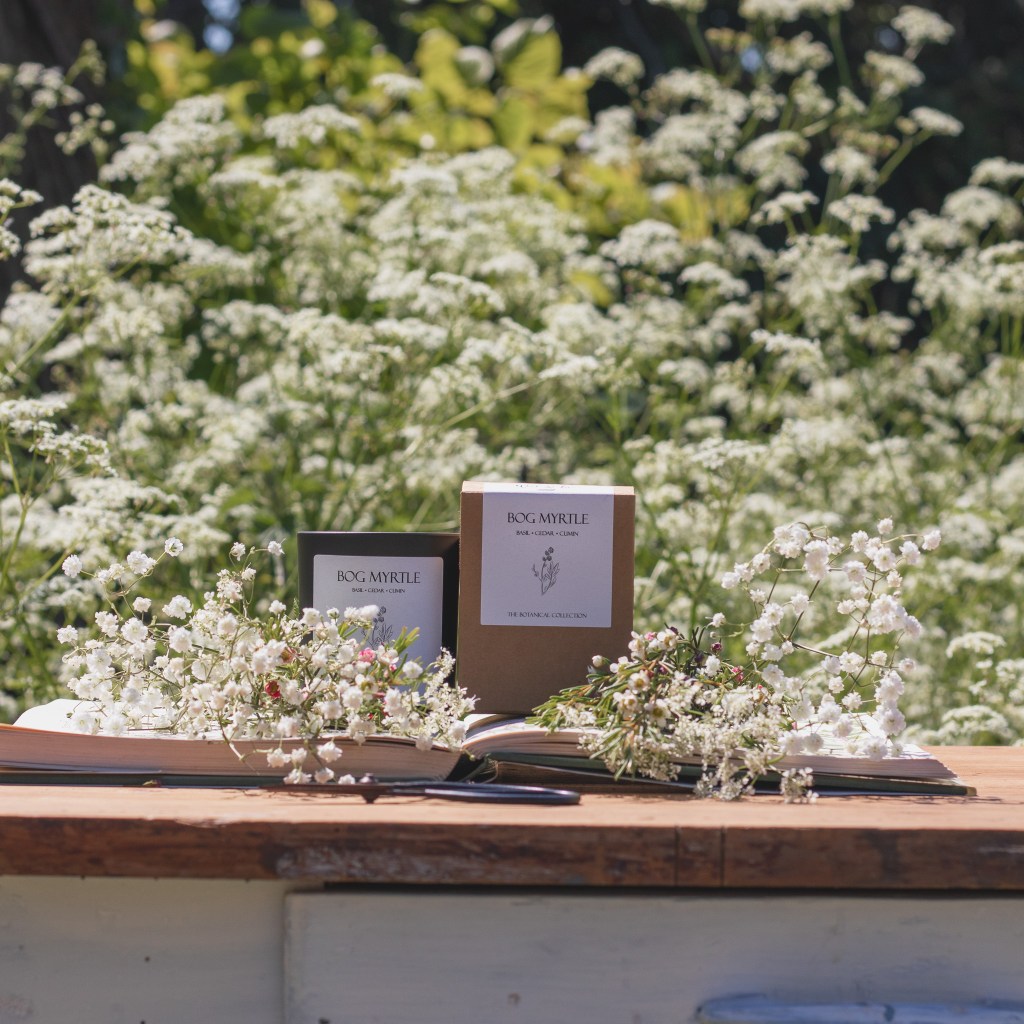 Wick and Fern botanical candle photographed outdoors amongst cow parsley